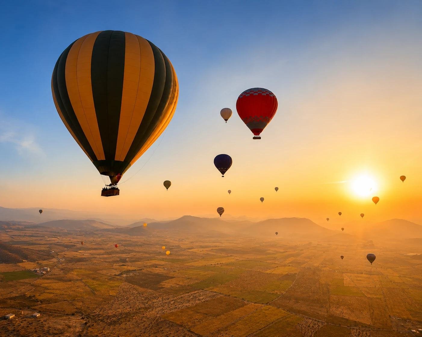 Hot air balloons in golden light over the countryside near Marrakech