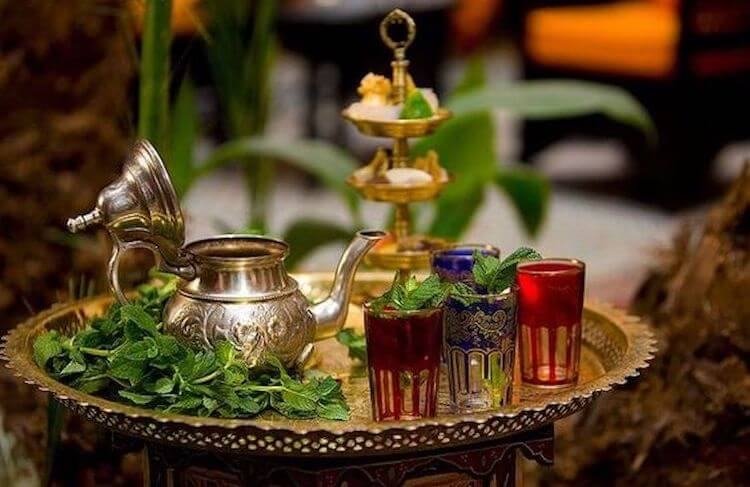 Moroccan mint tea served on a silver tray with pastries