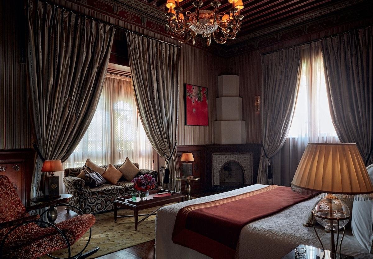 Palace suite with a painted cedar ceiling and chandelier in Marrakech